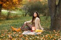 Beautiful caucasian girl on the nature picnic with fruits. Relaxing young woman in Nature. Autumn landscape background Royalty Free Stock Photo