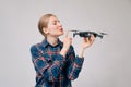 A beautiful Caucasian girl plans to kiss a quadcopter or a multicopter. Blogger teaches online how to shoot video from the air