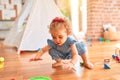 Beautiful caucasian infant playing with toys at colorful playroom