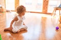 Beautiful caucasian infant playing with toys at colorful playroom