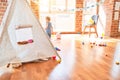 Beautiful caucasian infant playing with toys at colorful playroom