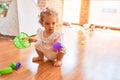 Beautiful caucasian infant playing with toys at colorful playroom