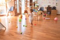 Beautiful caucasian infant playing with toys at colorful playroom