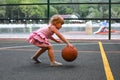 Beautiful caucasian little girl with a big ball on the playing field. Royalty Free Stock Photo