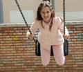 Beautiful caucasian little girl with long brown hair plays with Royalty Free Stock Photo