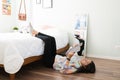 Cute teen girl enjoying a novel in her bedroom floor Royalty Free Stock Photo