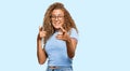 Beautiful caucasian teenager girl wearing casual clothes and glasses pointing fingers to camera with happy and funny face Royalty Free Stock Photo