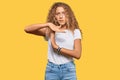 Beautiful caucasian teenager girl wearing casual white tshirt doing time out gesture with hands, frustrated and serious face Royalty Free Stock Photo