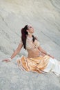 Young beautiful woman belly dancer posing in peach costume Royalty Free Stock Photo