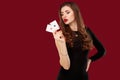 Beautiful caucasian woman in black dress with poker cards gambling in casino Royalty Free Stock Photo