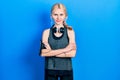 Beautiful caucasian woman with blond hair wearing sportswear happy face smiling with crossed arms looking at the camera Royalty Free Stock Photo