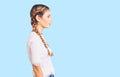 Beautiful caucasian woman with blonde hair wearing braids and white tshirt looking to side, relax profile pose with natural face Royalty Free Stock Photo