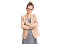 Beautiful caucasian woman with blonde hair wearing business jacket and glasses skeptic and nervous, disapproving expression on Royalty Free Stock Photo