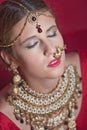 Beautiful caucasian woman with braided hair dressed in Indian bridal Sari along with specific jewelry