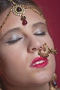 Beautiful caucasian woman with braided hair dressed in Indian bridal Sari along with specific jewelry