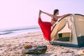 A Beautiful caucasian woman dancing making yoga and cook near tent. Royalty Free Stock Photo