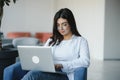 Beautiful Caucasian woman dreaming about something while sitting with portable net-book in modern cafe bar, young Royalty Free Stock Photo