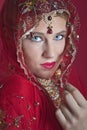 Beautiful caucasian woman dressed in Indian bridal Sari along with specific jewelry: Mangalsutra, Thaali, Maang Tikka, Choora, Nat