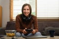 Beautiful caucasian woman in headset holding joystick playing video game at home