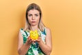 Beautiful caucasian woman holding piggy bank depressed and worry for distress, crying angry and afraid Royalty Free Stock Photo