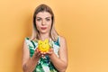 Beautiful caucasian woman holding piggy bank relaxed with serious expression on face Royalty Free Stock Photo