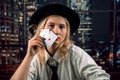 Beautiful Caucasian woman with poker cards near her face covering herself Royalty Free Stock Photo