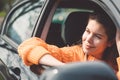 Beautiful caucasian woman portrait, fixing her sunglasses while driving in her car