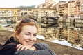 Beautiful caucasian woman posing in front of amazing bridge Ponte Vecchio, Florence, Italy Royalty Free Stock Photo