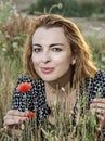 Beautiful caucasian woman posing in poppy flowers field, beauty, fashion and nature Royalty Free Stock Photo