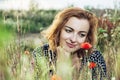 Beautiful caucasian woman posing with poppy flowers field, summer time Royalty Free Stock Photo