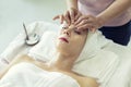 Beautiful caucasian woman relaxation and lying, spa massage on face in spa salon Royalty Free Stock Photo