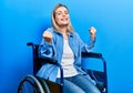 Beautiful caucasian woman sitting on wheelchair very happy and excited doing winner gesture with arms raised, smiling and Royalty Free Stock Photo