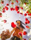 Beautiful caucasian woman smile picking poppy flower outdoors with sky background Royalty Free Stock Photo