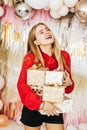 Beautiful Caucasian woman smiles with a Christmas presen