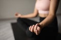 Beautiful caucasian woman in sportswear practices yoga on the mat at home. close hand