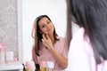 Beautiful caucasian woman use perfume in a bedroom, reflection in a mirror portrait Royalty Free Stock Photo