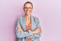 Beautiful caucasian woman wearing business jacket and glasses happy face smiling with crossed arms looking at the camera Royalty Free Stock Photo