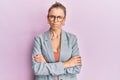 Beautiful caucasian woman wearing business jacket and glasses skeptic and nervous, disapproving expression on face with crossed Royalty Free Stock Photo