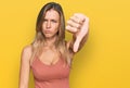 Beautiful caucasian woman wearing casual clothes looking unhappy and angry showing rejection and negative with thumbs down gesture Royalty Free Stock Photo