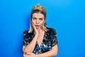 Beautiful caucasian woman wearing princess crown thinking looking tired and bored with depression problems with crossed arms