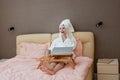 young beautiful caucasian woman in white bathrobes and towels on heads Royalty Free Stock Photo