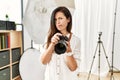 Beautiful caucasian woman working as photographer at photography studio depressed and worry for distress, crying angry and afraid Royalty Free Stock Photo
