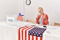 Beautiful caucasian woman working at political campaign pointing fingers to camera with happy and funny face