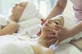 Beautiful caucasian women relaxation and lying, spa massage on face in spa salon