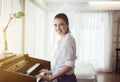 Beautiful Caucasian young woman playing electric piano,Happy and smiling,Relaxing time Royalty Free Stock Photo