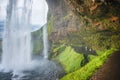 Beautiful, with cave inside Seljalandsfoss waterfall in South Iceland, summer time