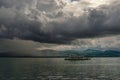 Beautiful cene of a ship in the middle of the sea under gray cloudy sky on the horizon Royalty Free Stock Photo