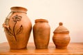 A beautiful ceramic earthenware pitcher with a pattern of handmade flowers and pots. Traditional clay potato, flower vase