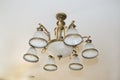 Close-up - a beautiful chandelier with a bronze frame and white marble shades