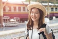 Beautiful charming Asian woman with smile in white t-shirt wearing straw hat and backpack Royalty Free Stock Photo